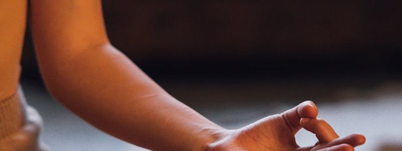 A person sitting in a zen pose meditating.
